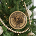 A Christmas tree decorated with ornaments, including a circular ornament with a boerboel dog image and the text "BOERBOEL DOG" on it.