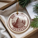 A circular ornament with the text "BOROBUDUR INDONESIA" printed on it, hanging from a string.