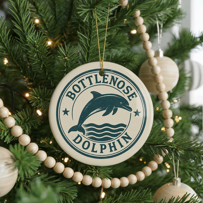 A Christmas tree decorated with ornaments, including a round ornament with a dolphin and the text "Bottlenose Dolphin".