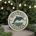A round ornament with the text "Bottlenose Dolphin" and a graphic of a dolphin jumping out of the water, hanging from a string.