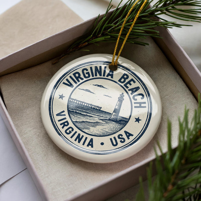 A decorative ornament in a box, featuring a lighthouse and the text "VIRGINIA BEACH USA".