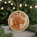 A circular ornament featuring a brown dog's head, with the text "Vizsla Dog" written around the edge.