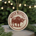A circular ornament featuring a brown buffalo with large horns, surrounded by a red border and the text "WATER BISON" in a decorative font.