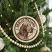 A Christmas tree decorated with ornaments, including a circular ornament with a dog's head and the text "BRACCO ITALIANO" printed on it.