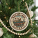A circular ornament on a Christmas tree, featuring a castle and the text "Bratislava, Slovakia".