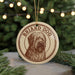 A circular ornament featuring a brown and white illustration of a dog's head, with the text "BRIDD DOG" written around the edge.