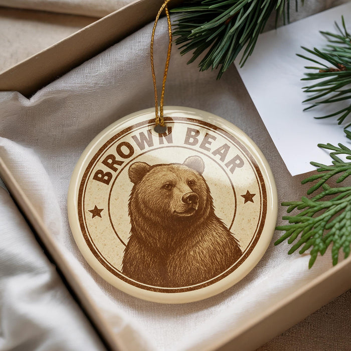 A brown bear ornament with the text "Brown Bear" is displayed in a box, surrounded by pine branches.