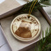 A circular ornament featuring a brown bear image, with the text "Brown Bear" prominently displayed.