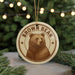 A circular ornament featuring a brown bear image, with the text "BROWN BEAR" around the edge.