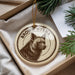 A circular ornament with a brown hyena image and the text "BROWN HYENA" on it, hanging from a string.