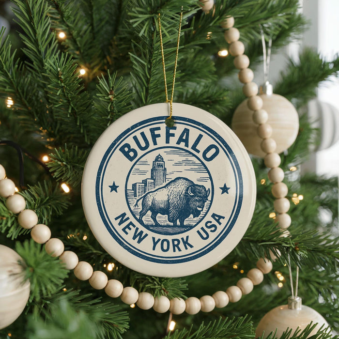 A circular ornament on a Christmas tree, featuring a buffalo and the text "BUFFALO NEW YORK USA".