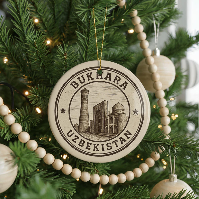 A circular ornament on a Christmas tree, featuring the text "BUKHARA UZBEKISTAN" and an illustration of a mosque.