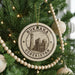 A circular ornament on a Christmas tree, featuring the text "BUKHARA UZBEKISTAN" and an illustration of a mosque.