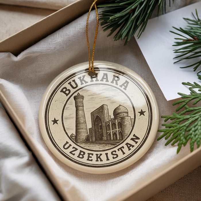A circular ornament with the text "BUKHARA UZBEKISTAN" and an illustration of a mosque, hanging from a string.