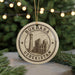 A circular ornament with the text "BUKHARA UZBEKISTAN" and an illustration of a mosque, hanging from a string.
