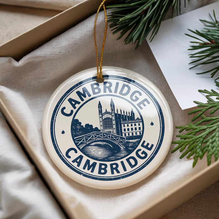 A decorative ornament with the text "CAMBRIDGE" and an illustration of a castle or palace, hanging from a string.