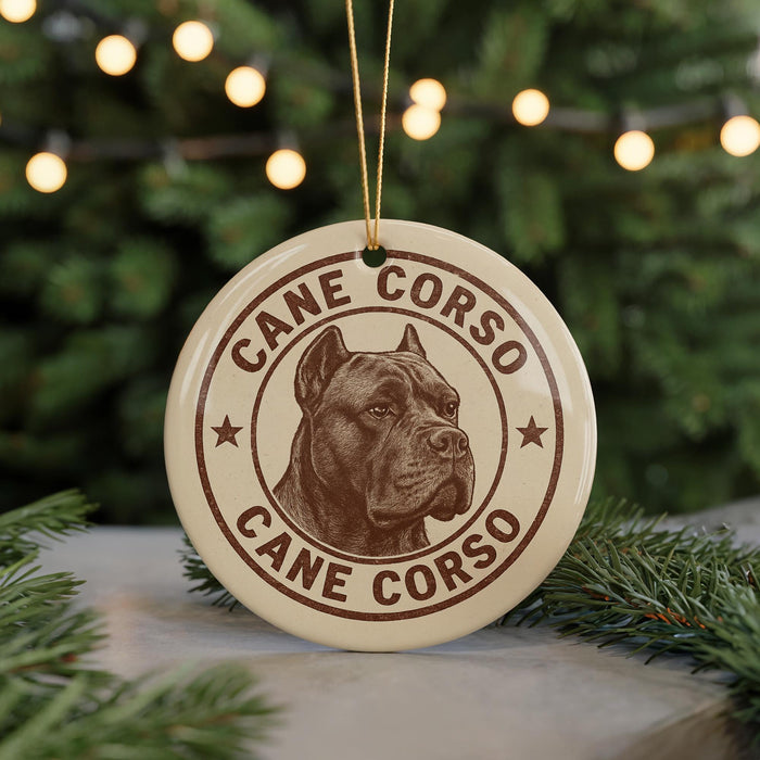 A round ornament featuring a brown and white image of a dog's head, with the text "CANE CORSO" and "CANE CORSO" written around the edge.