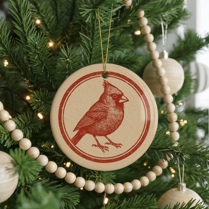 A Christmas tree decorated with ornaments, including a red cardinal ornament hanging from the tree.