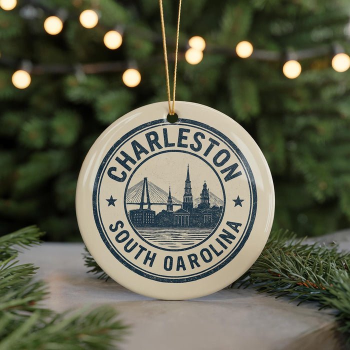 A circular ornament with the text "CHARLESTON SOUTH OCAROLINA" and a graphic of a bridge, hanging from a string.