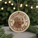 A round ornament featuring a brown dog's head, with the text "CHESAPEAKE BAY RETRIEVER" printed on it, hanging from a string.