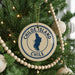 A Christmas tree decorated with ornaments, including a circular ornament with the text "CHILE" and a map of Chile.