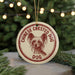 A round ornament with a red and white design featuring a dog's face and the text "CHINESE CREsted DOG DOG" is displayed in front of a blurred Christmas tree.