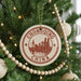 A Christmas tree decorated with ornaments, including a circular ornament with the text "CHONGQING CHINA" and a cityscape illustration.