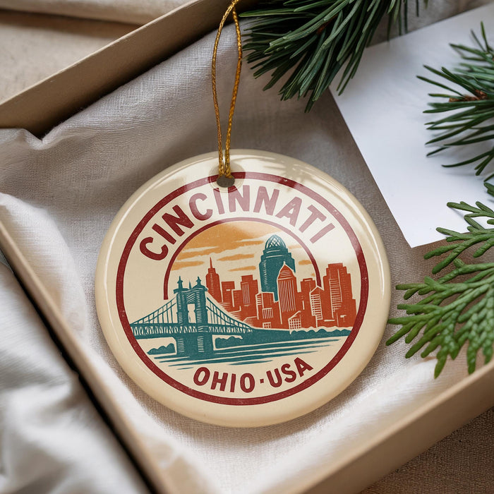 A decorative ornament featuring the Cincinnati skyline, with a bridge and the text "CINCINNATI, OHIO, USA" prominently displayed.