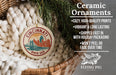 Ceramic ornaments, featuring a Cincinnati, Ohio, USA design, are displayed in a basket with greenery.