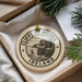 A circular ornament with the text "CLIFFS OF MOHER IRELAND" printed on it, surrounded by a decorative string.