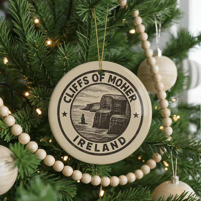 A Christmas tree decorated with ornaments, including a circular ornament with the text "CLIFFS OF MOHER IRELAND" and a beaded ornament.
