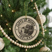 A Christmas tree decorated with ornaments, including a circular ornament with the text "CLIFFS OF MOHER IRELAND" and a beaded ornament.