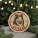 A round ornament featuring a collie dog's head, with the name "COLLEIE" written below it, is hanging from a string.