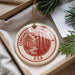 A circular ornament with the text "CONGAREE NATIONAL PARK USA" printed on it, hanging from a string.