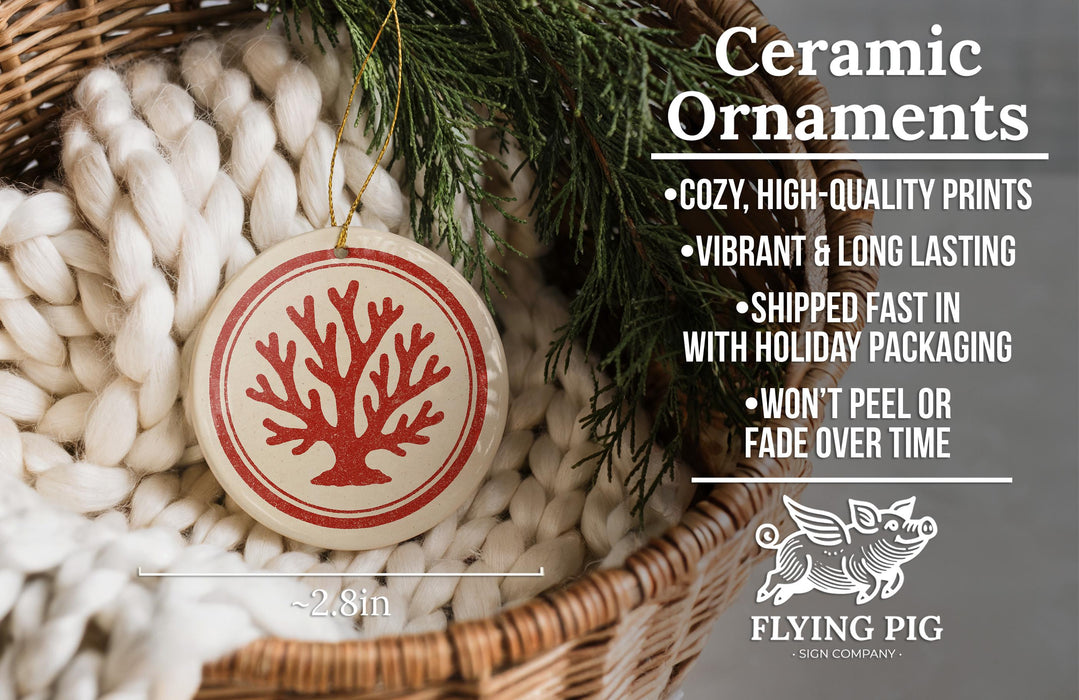 Ceramic ornaments, featuring a red tree design, are displayed in a woven basket.