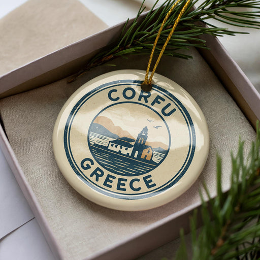 A circular ornament with the text "CORFU GREECE" and a graphic of a building and mountains, hanging from a string.