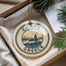 A decorative ornament with the text "CORFU GREECE" and a graphic of a building and mountains, hanging from a string.