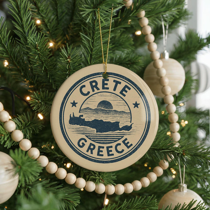 A circular ornament on a Christmas tree with the text "CRETE GREECE" printed on it.