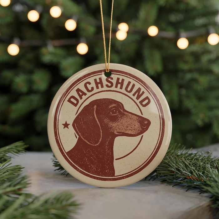 A circular ornament featuring a dachshund dog's head, with the word "DACHSHUND" written around the edge.