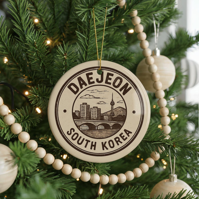 A Christmas tree decorated with ornaments, including a circular ornament with the text "DAEJEON SOUTH KOREA" and a cityscape illustration.
