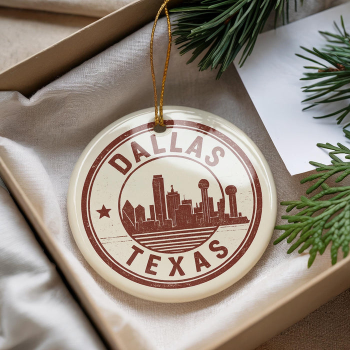 A circular ornament with the text "DALLAS TEXAS" and a graphic of the Dallas skyline, hanging from a string.