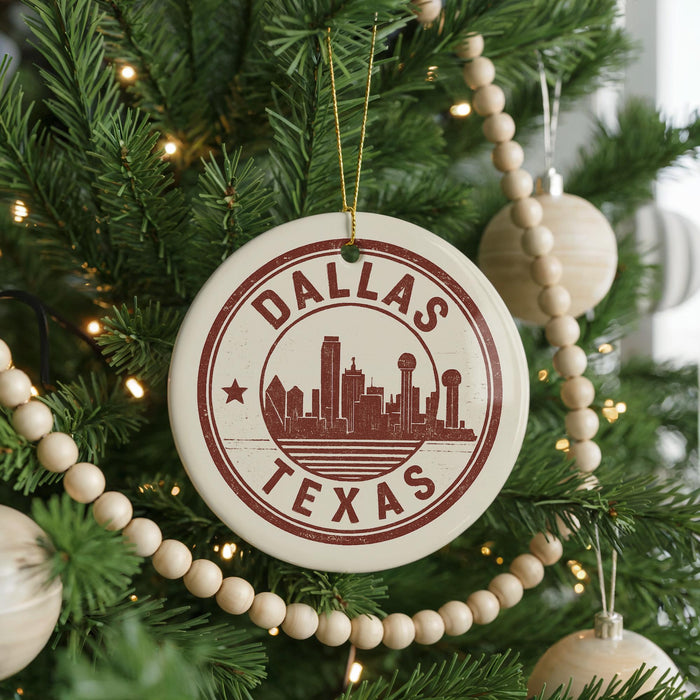 A Christmas tree decorated with ornaments, including a circular ornament with the text "DALLAS TEXAS" and a city skyline silhouette.