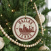A Christmas tree decorated with ornaments, including a circular ornament with the text "DALLAS TEXAS" and a city skyline silhouette.