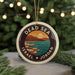 A circular ornament with a design depicting a beach and mountains, surrounded by the text "DEAD SEA ISRAEL" and "JORDAN".