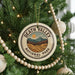 A Christmas tree decorated with ornaments, including a circular ornament with the text "DEATH VALLEY NATIONAL PARK USA" and a landscape illustration.