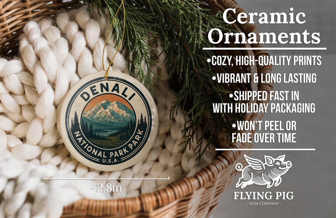 Ceramic ornaments, featuring a design of a mountain landscape with pine trees, are displayed in a woven basket.
