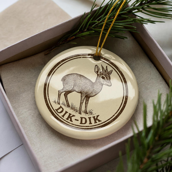 A ceramic ornament in a box, featuring a deer illustration and the text "DIK-DIK".