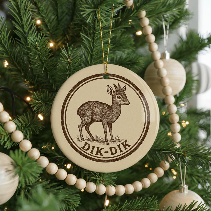 A Christmas tree decorated with ornaments, including a circular ornament with a deer image and the text "DIK-DIK".