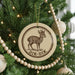 A Christmas tree decorated with ornaments, including a circular ornament with a deer image and the text "DIK-DIK".