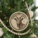 A Christmas tree decorated with ornaments, including a circular ornament with a goat image and the text "Domestic Goat" on it.
